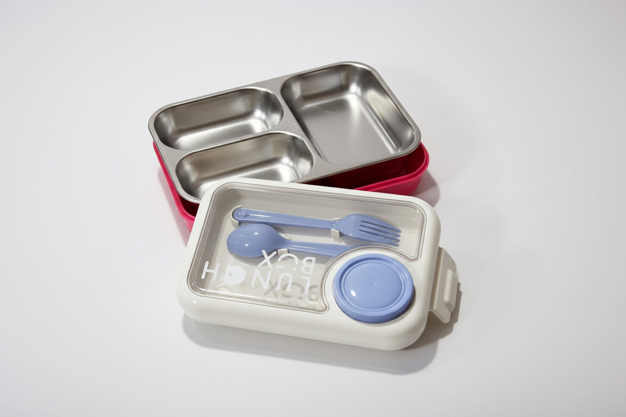 Set of stainless steel lunch containers with cutlery on a white background