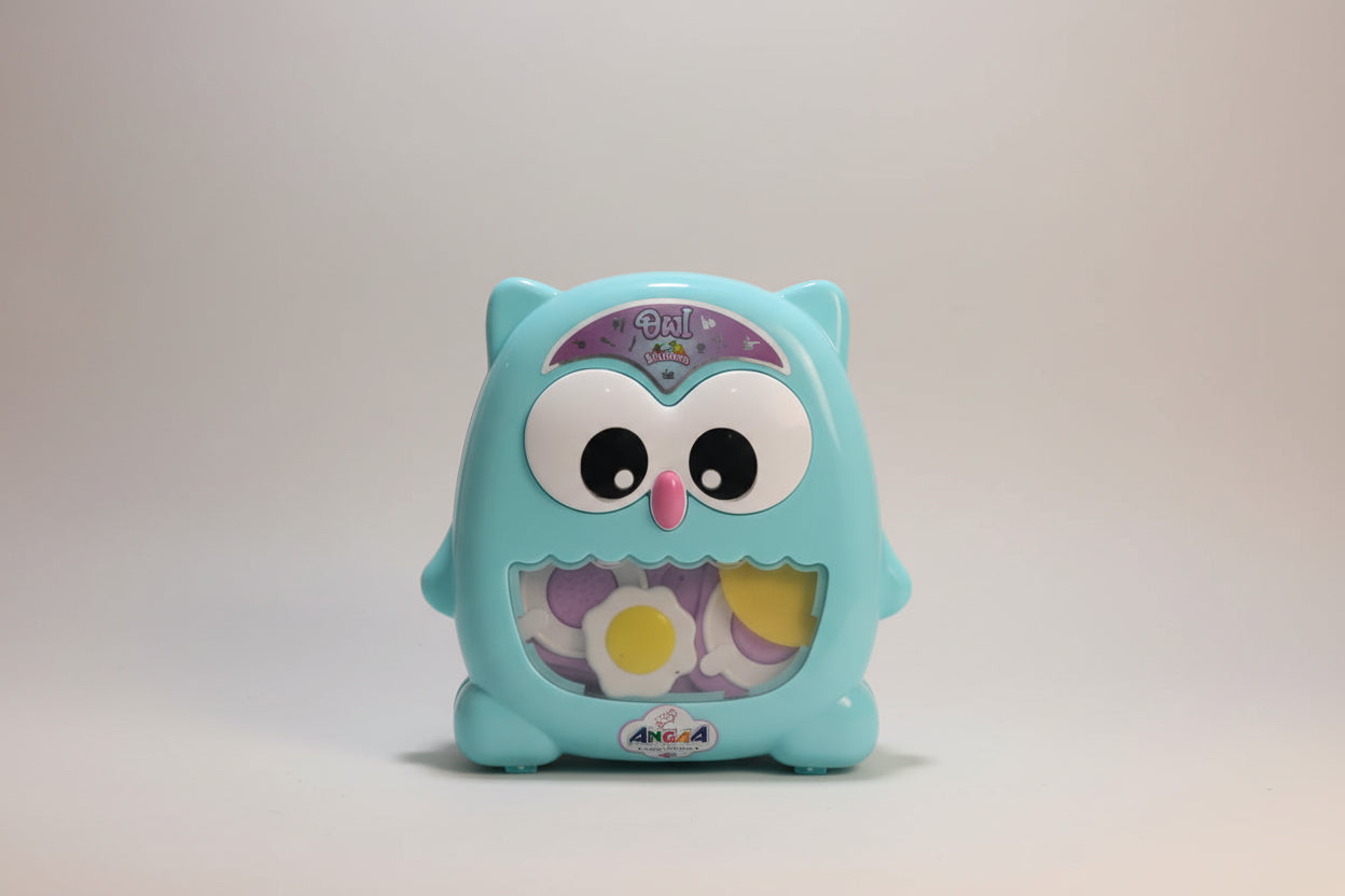 Blue owl-shaped toy with a colorful face on a white background