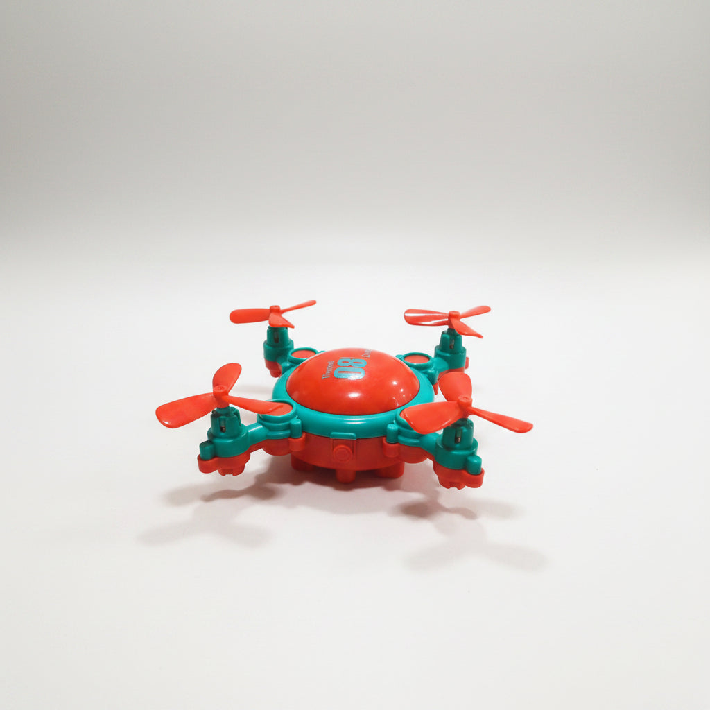 A red and blue friction-powered drone-style toy car with moving fans.