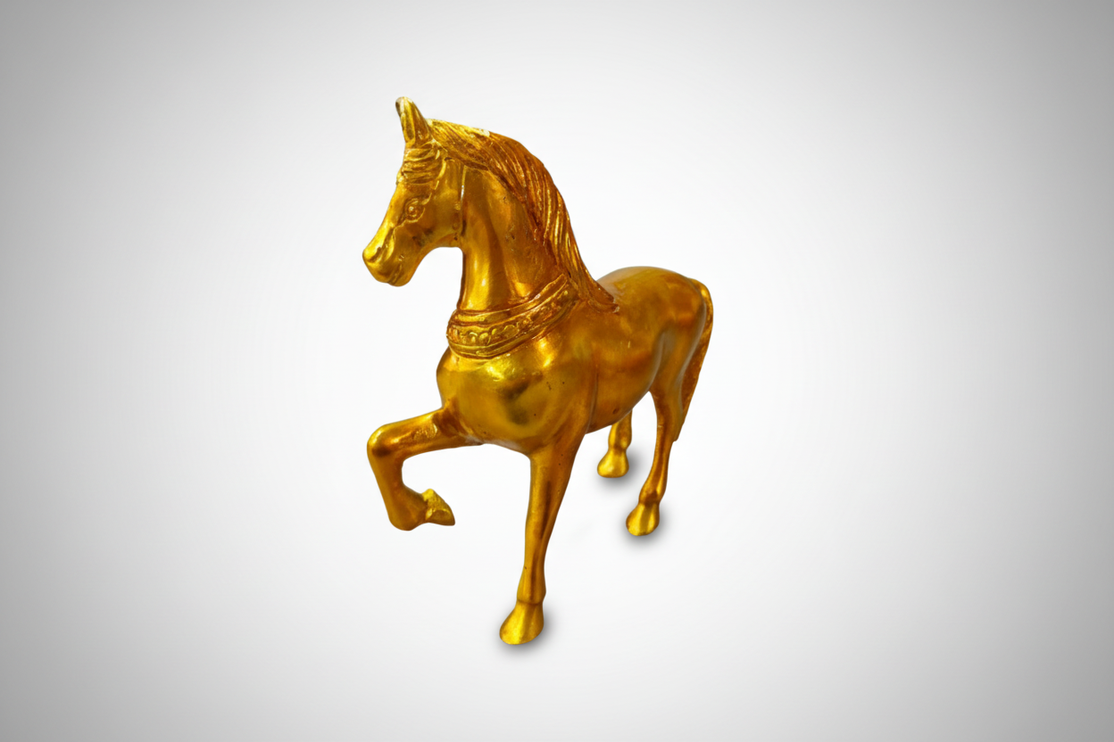 Gold horse figurine on a white background