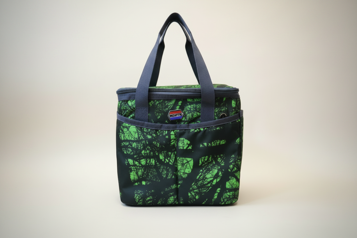 A medium-sized black lunch bag with a green leaf pattern, featuring handles and a label.