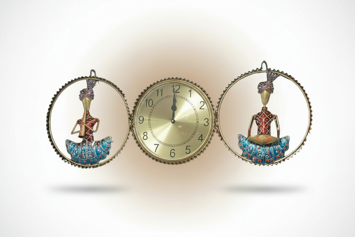 A metal wall clock decor featuring a central clock with a golden clock face, surrounded by two decorative figures in blue and red.