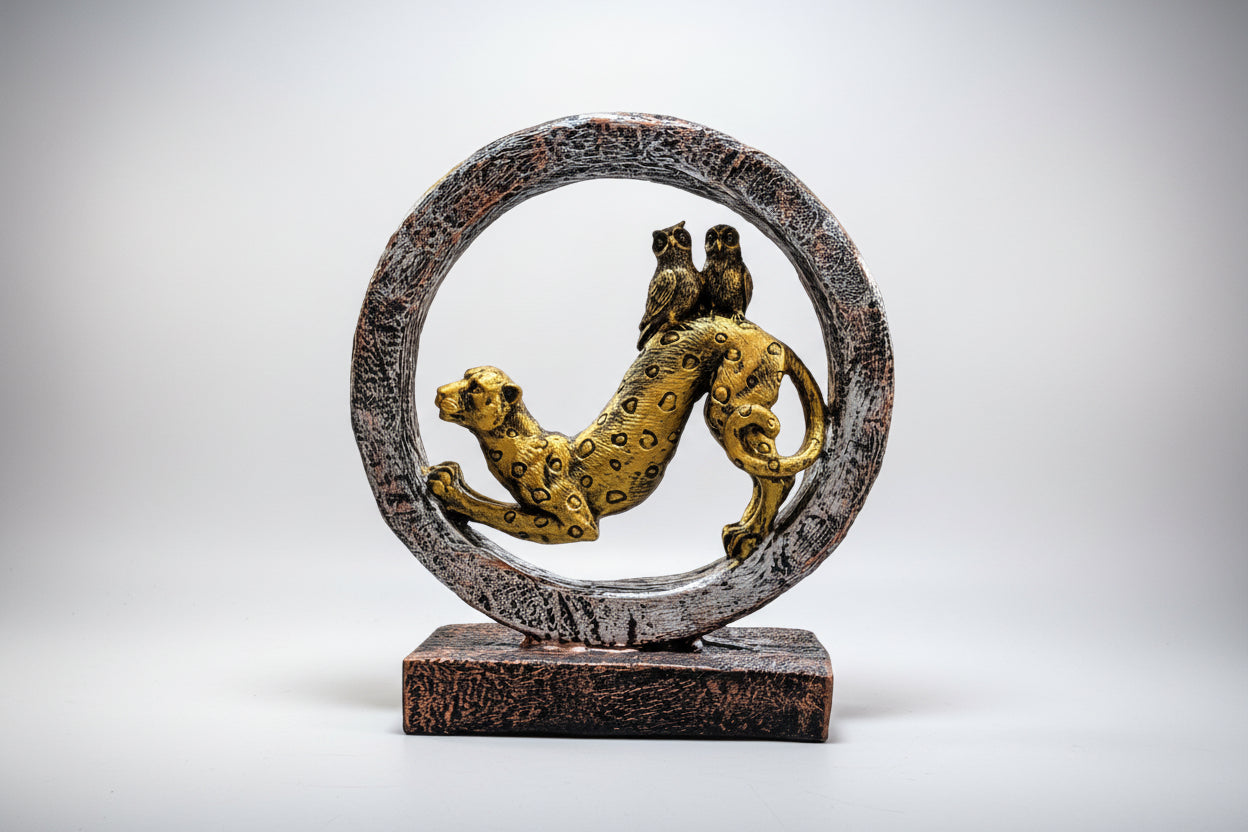 Decorative sculpture of a panther and snake in a circular design on a white background