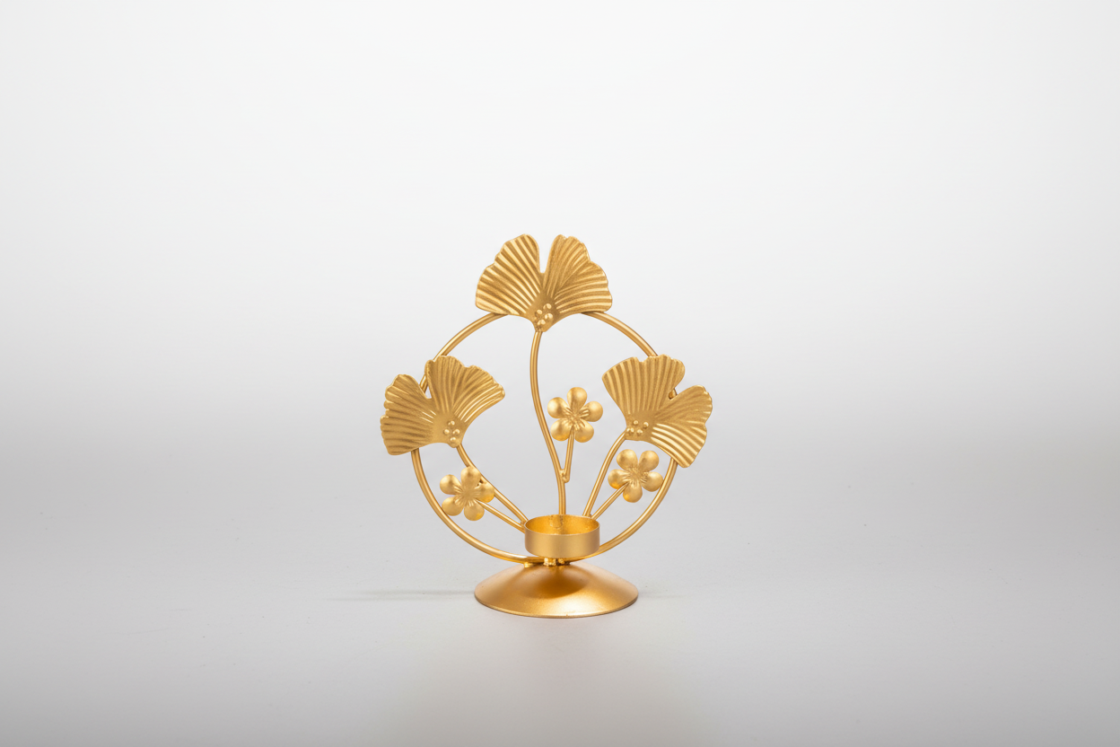 Gold decorative item with leaf design on a white background