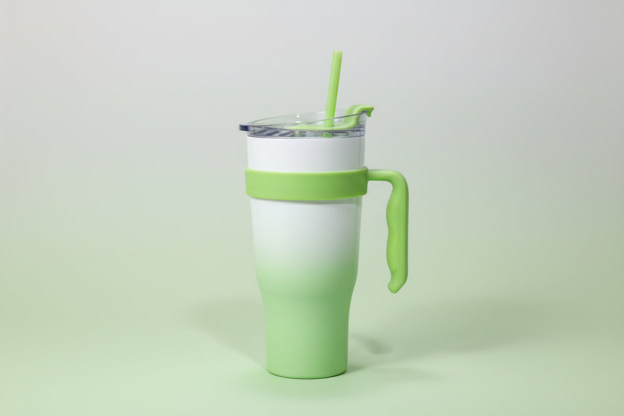 Green and white travel mug on a white background