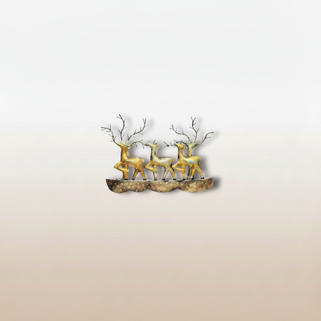 A wall decor featuring a bronze-colored deer standing on a rock, mounted on a wall above a beige sofa in a living room setting.