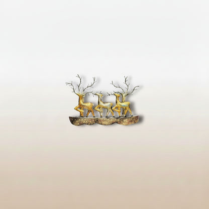 A wall decor featuring a bronze-colored deer standing on a rock, mounted on a wall above a beige sofa in a living room setting.