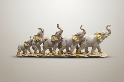 Decorative figurine of elephants with gold accents on a white background
