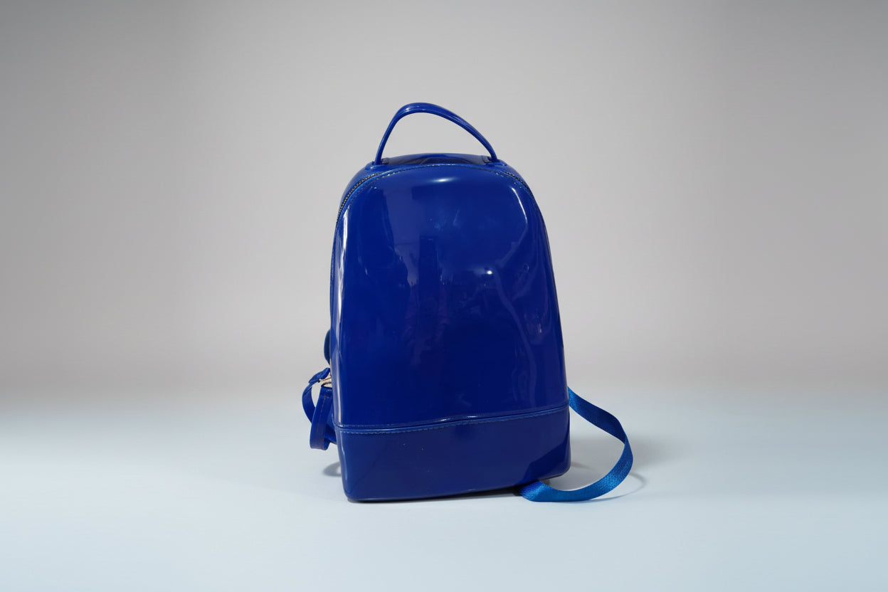 A solid blue silicone backpack with adjustable straps, designed for children.