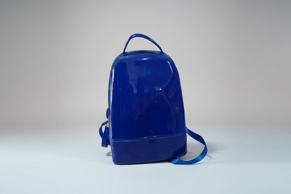 A solid blue silicone backpack with adjustable straps, designed for children.