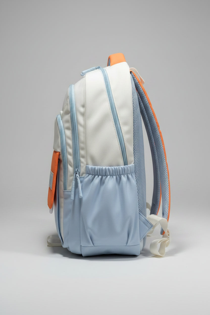 Light blue backpack with orange accents on a gray surface