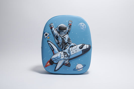 A hardshell backpack with a 3D print design featuring an astronaut and space-themed graphics on a blue background.
