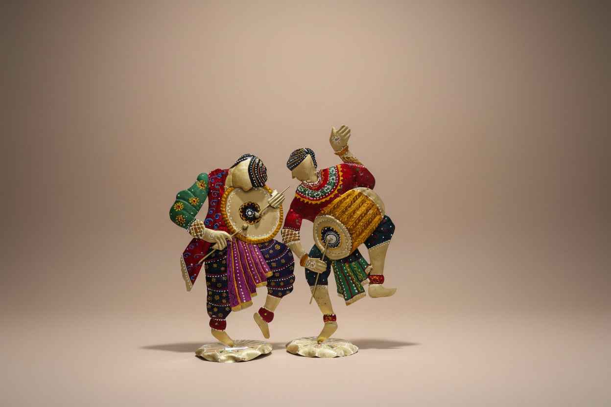 A set of two metal figurines depicting traditional Bhangra dancers in vibrant costumes.