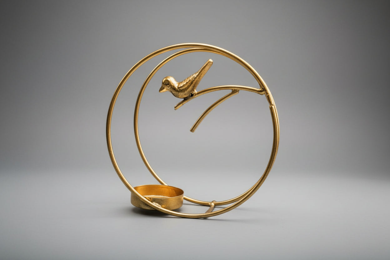 Decorative gold metal sculpture of a bird on a branch with a circular frame.