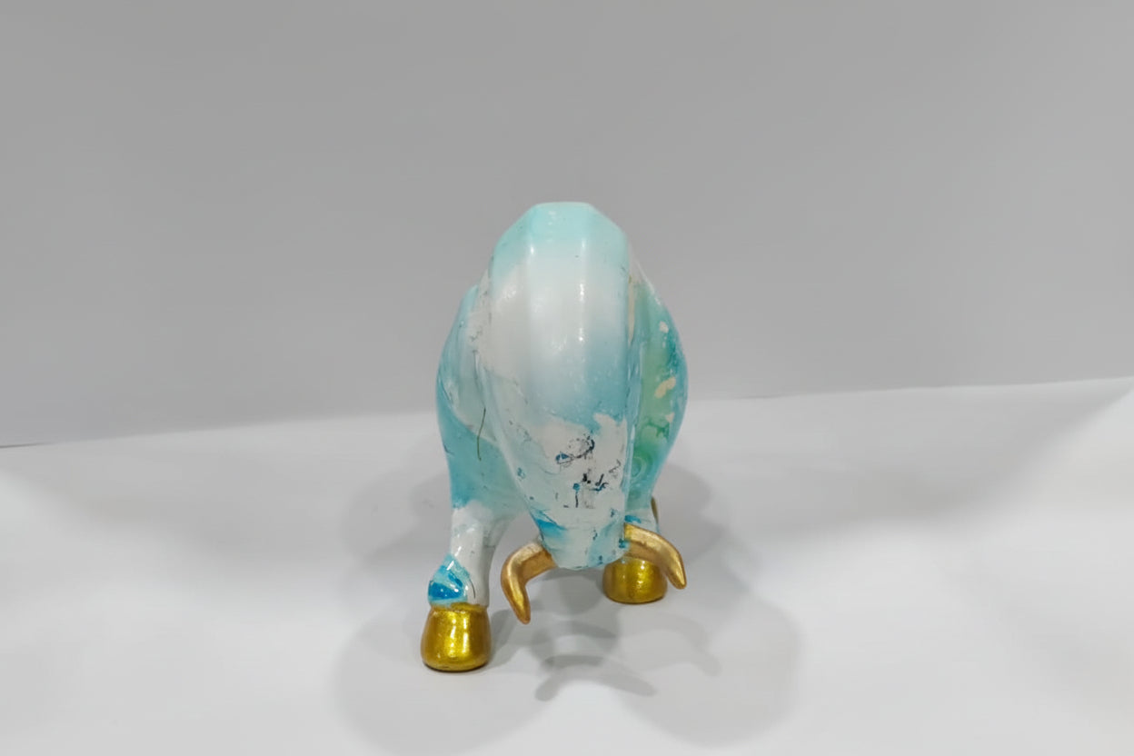Decorative figurine of a bull with a blue and white pattern on a gray background