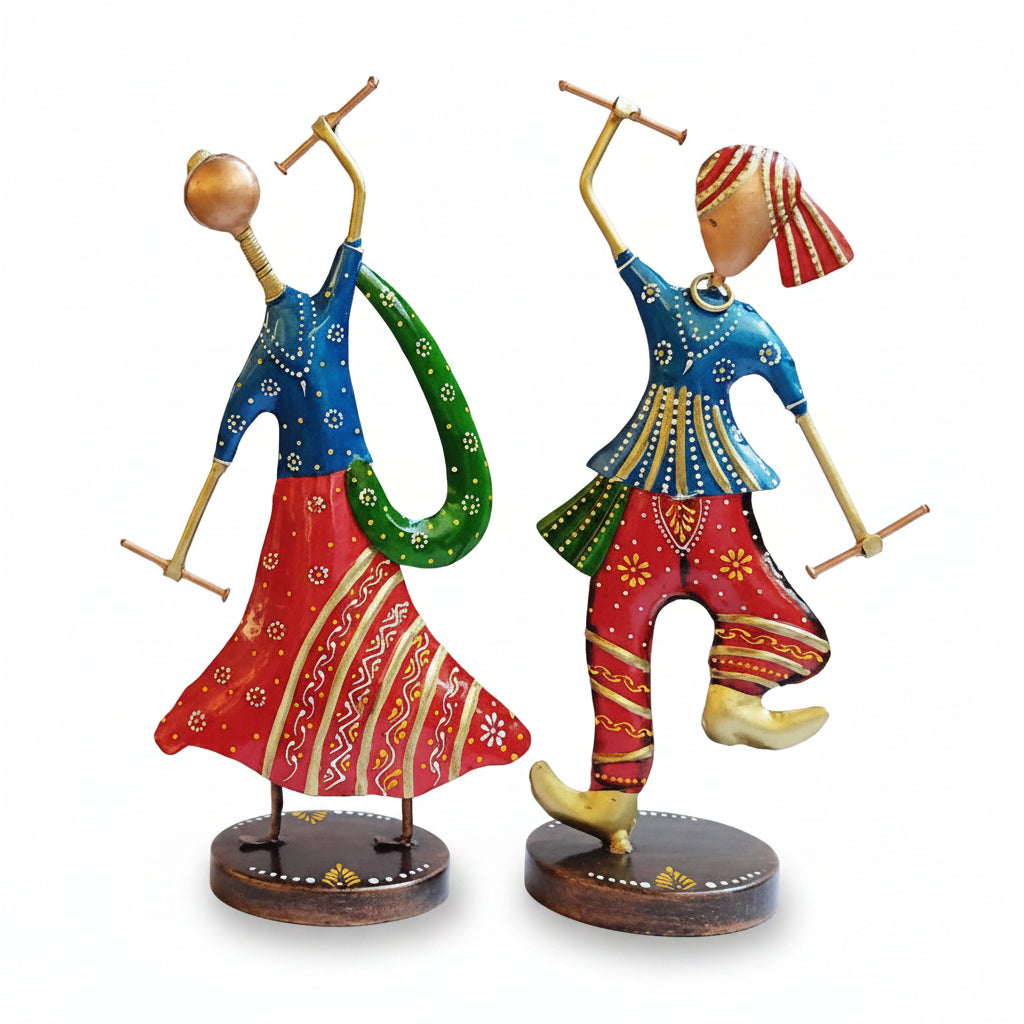 A set of two decorative metal showpieces featuring hand-painted figurines of Garba dancers in traditional attire, posed in dance stances.