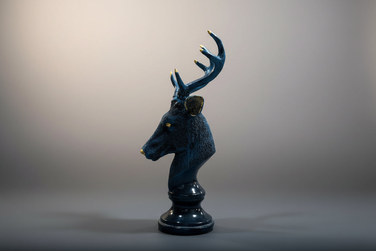 Black deer head sculpture on a white background