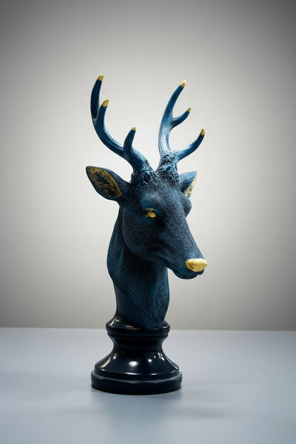Decorative deer head sculpture with blue and gold accents on a white background