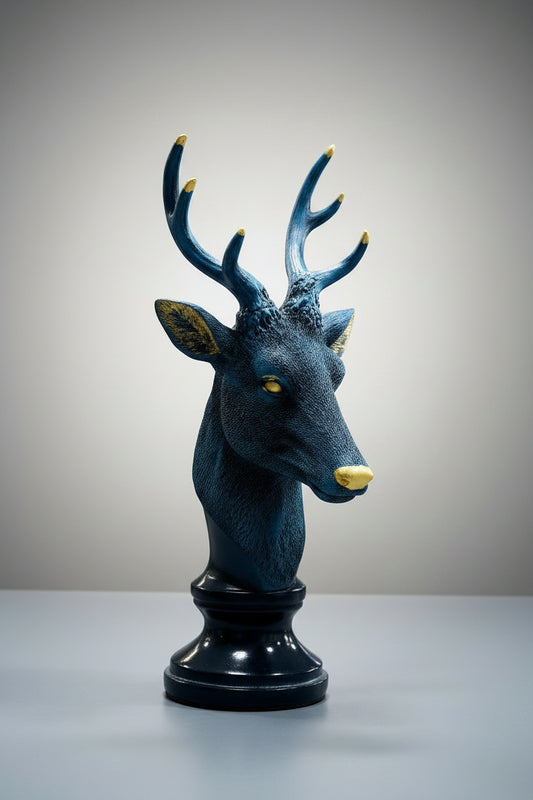 Decorative deer head sculpture with blue and gold accents on a white background