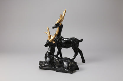 Black marble deer sculpture on a white background