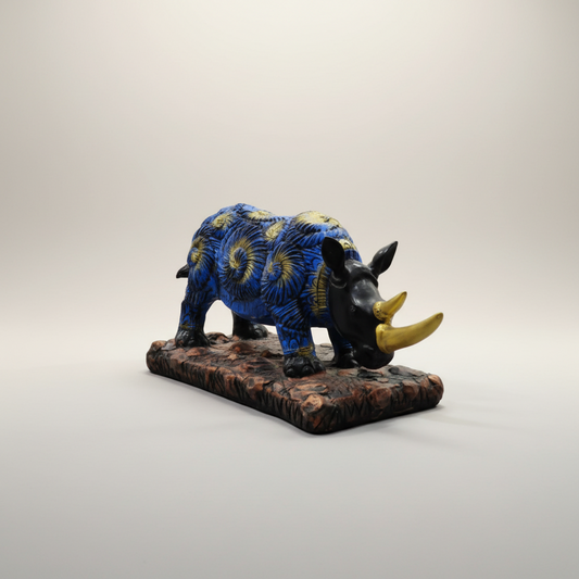 Decorative armadillo figurine with blue and gold design on a white background
