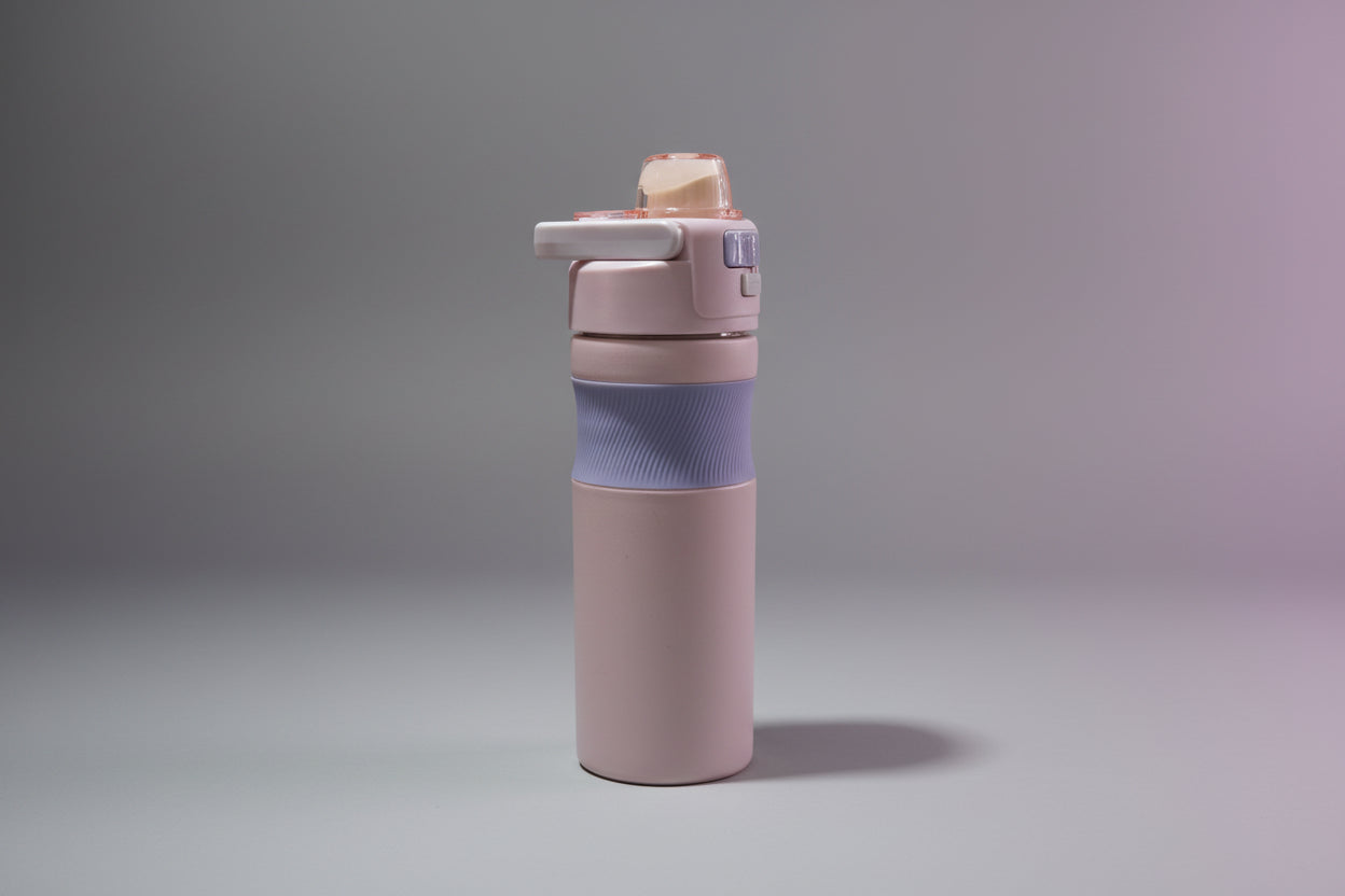 Purple water bottle with a blue sleeve on a white background