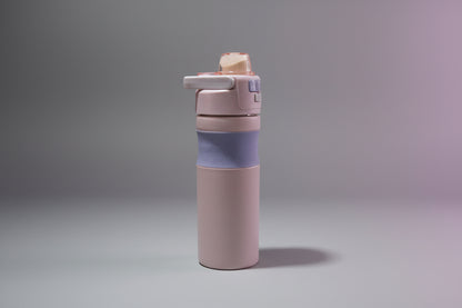 Purple water bottle with a blue sleeve on a white background