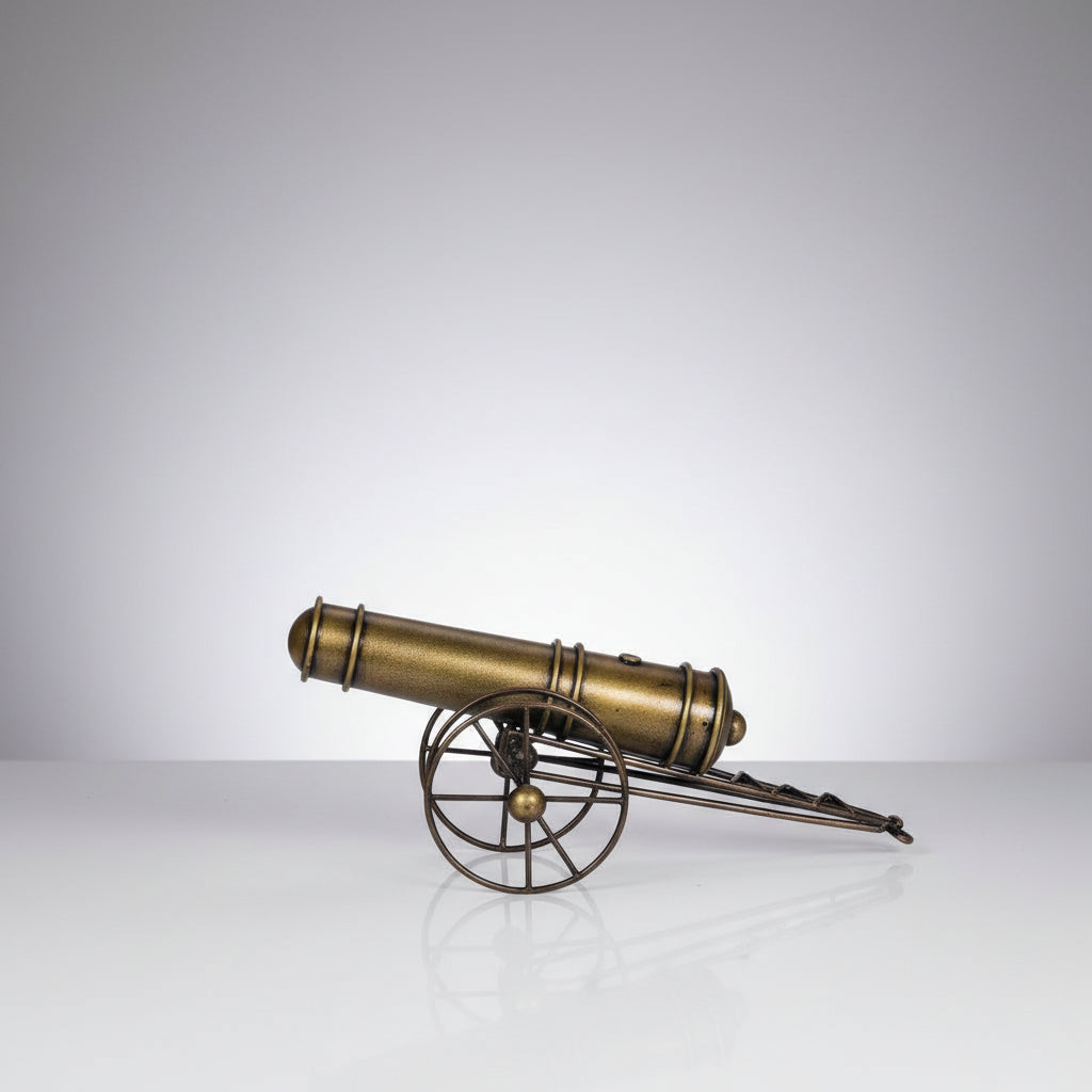 A bronze-colored metal showpiece designed to resemble an iron cannon with wheels and a barrel, mounted on a spherical base.