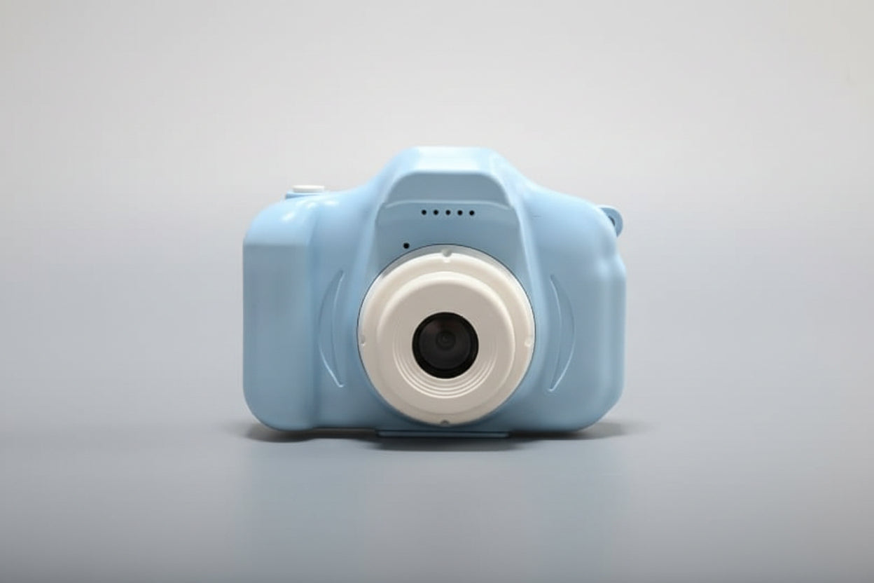 Blue toy camera with a white lens on a white background