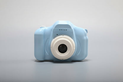 Blue toy camera with a white lens on a white background