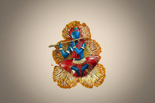 Metal wall decor featuring an LED light and a figure of Lord Krishna playing a flute, with a predominantly blue and red color scheme.