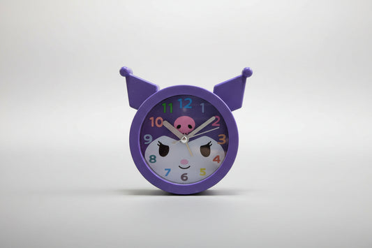 Children's clock with a purple border and cartoon face on a white background
