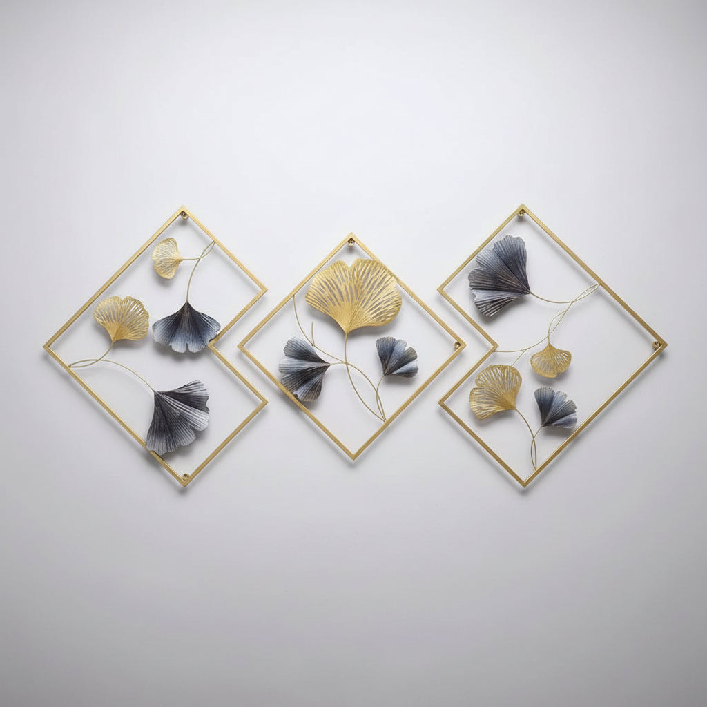 Decorative wall art with gold frames and blue and gold leaf-like elements in a living room setting.