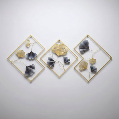 Decorative wall art with gold frames and blue and gold leaf-like elements in a living room setting.