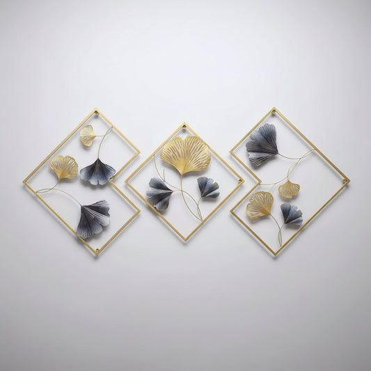 Decorative wall art with gold frames and blue and gold leaf-like elements in a living room setting.