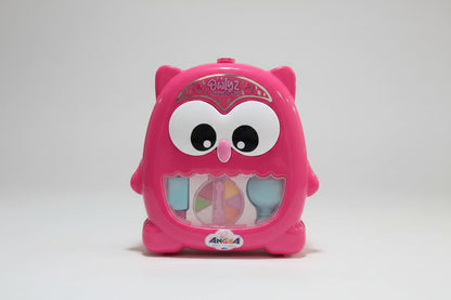 Pink owl-shaped makeup set with colorful compartments on a white background