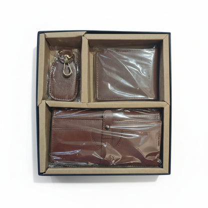 A leather wallet and clutch combo gift set presented in an open box with compartments holding a brown wallet and a clutch bag.
