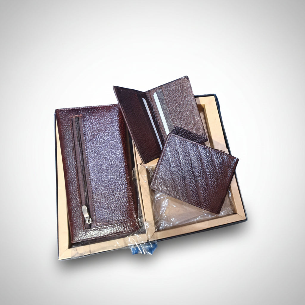 A leather wallet and clutch with card case displayed in an open box, showcasing the items to the viewer.