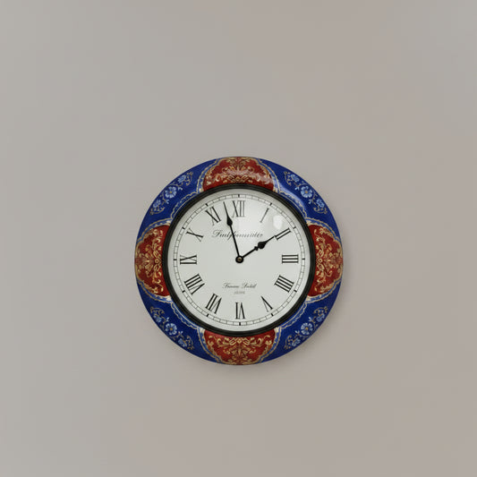 Decorative wall clock with blue and red floral design on a white background