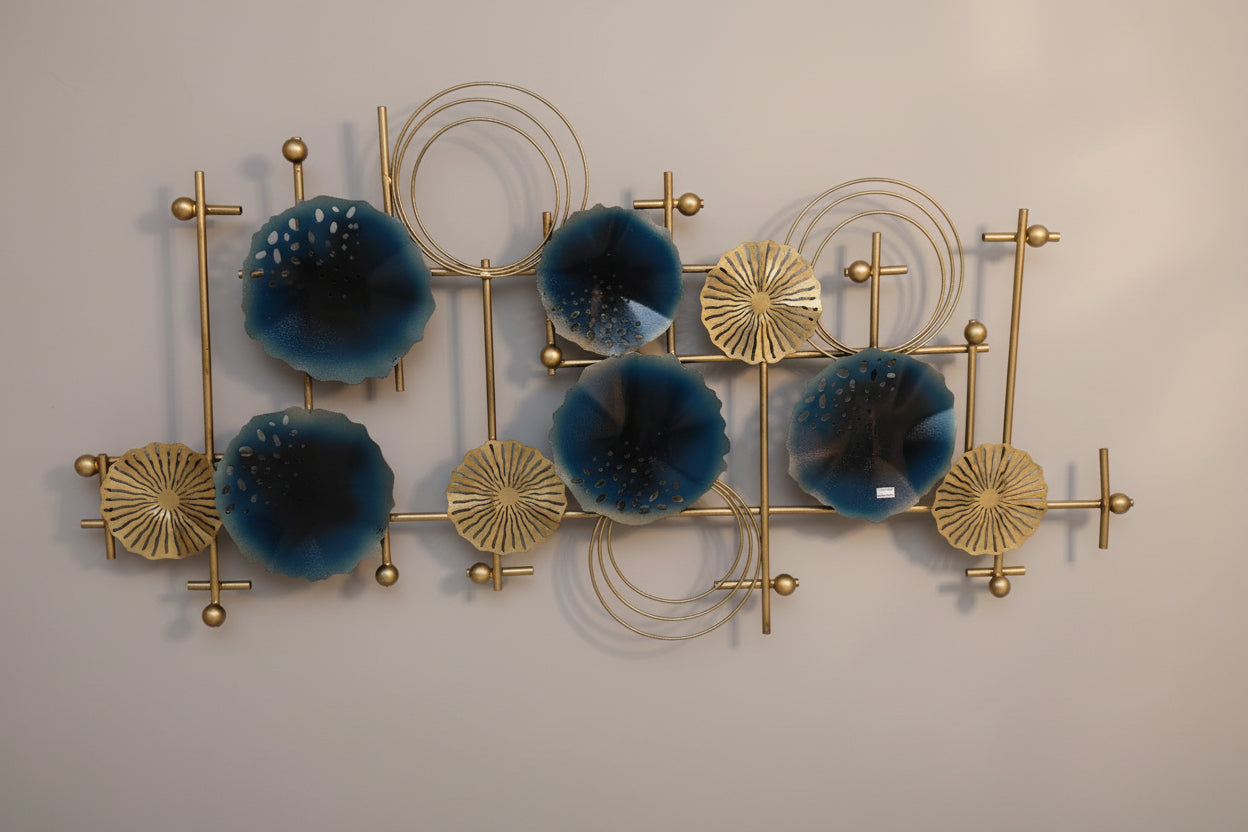 A contemporary style metal wall decor featuring a geometric pattern with multiple circular elements in blue and gold tones.