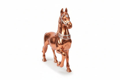 Copper horse figurine with a white background