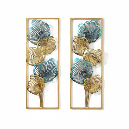 A set of two wrought iron wall panels with multicolor floral designs, displayed above a wooden console table with a classical statue on it, set against a light wall.