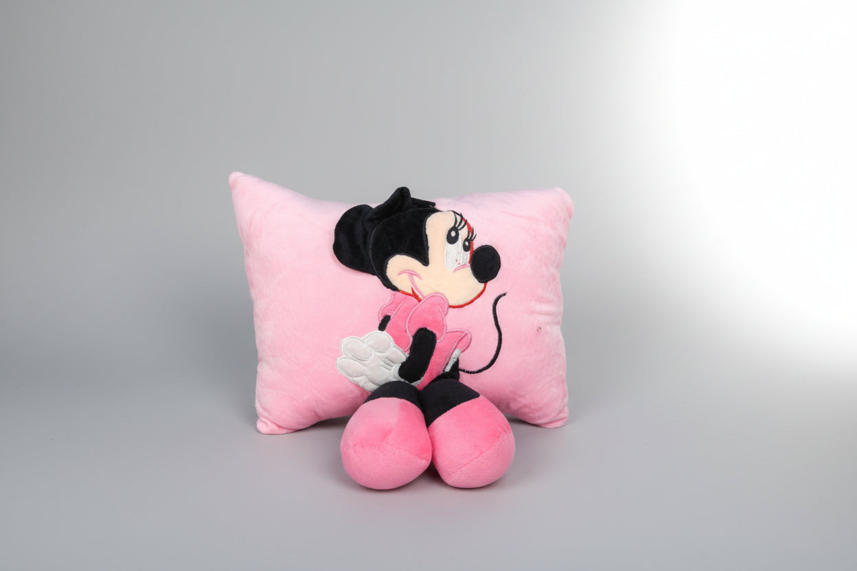 A plush toy depicting the character Minnie Mouse from Disney, designed as a pillow with a pink background.