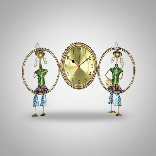 A decorative wall clock featuring a golden-colored frame with a musical theme, including a figure of a conductor and a second figure, both with green and multicolored details.