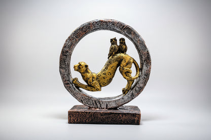 Decorative sculpture of a panther and snake in a circular design on a white background