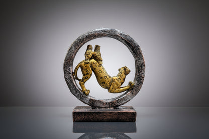 Bronze sculpture of a panther inside a circular ring on a wooden base