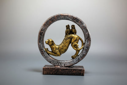 Decorative sculpture of a leopard inside a circular frame on a white background