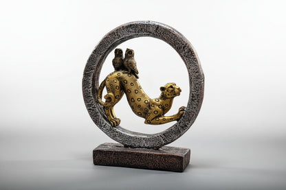 Decorative sculpture of a leopard inside a circular frame on a white background