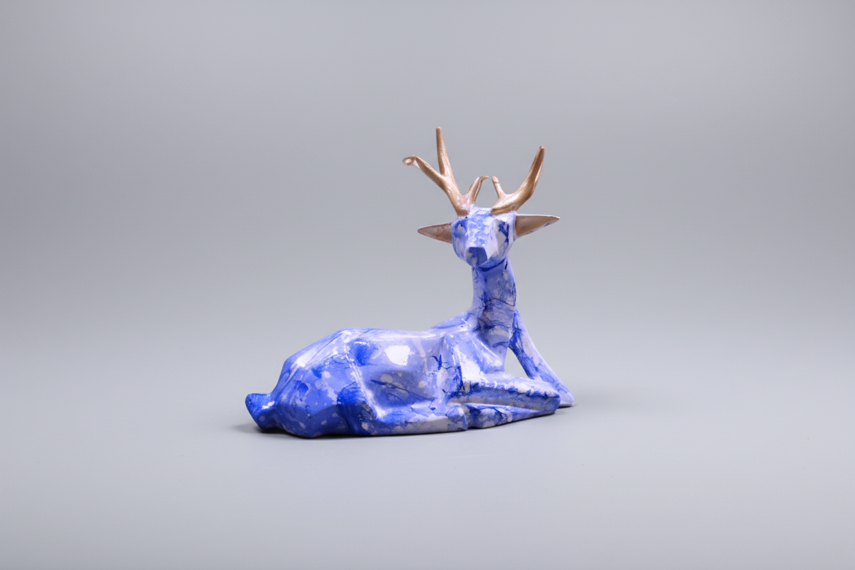 Blue glass deer figurine on a white background