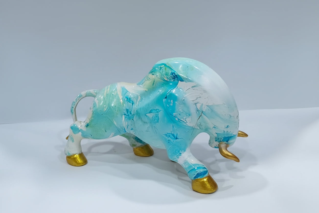 Decorative figurine of a bull with blue and white design on a white background